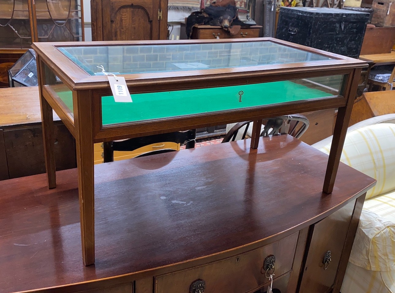 An Edwardian style glazed mahogany bijouterie low table, width 88cm, depth 45cm, height 46cm